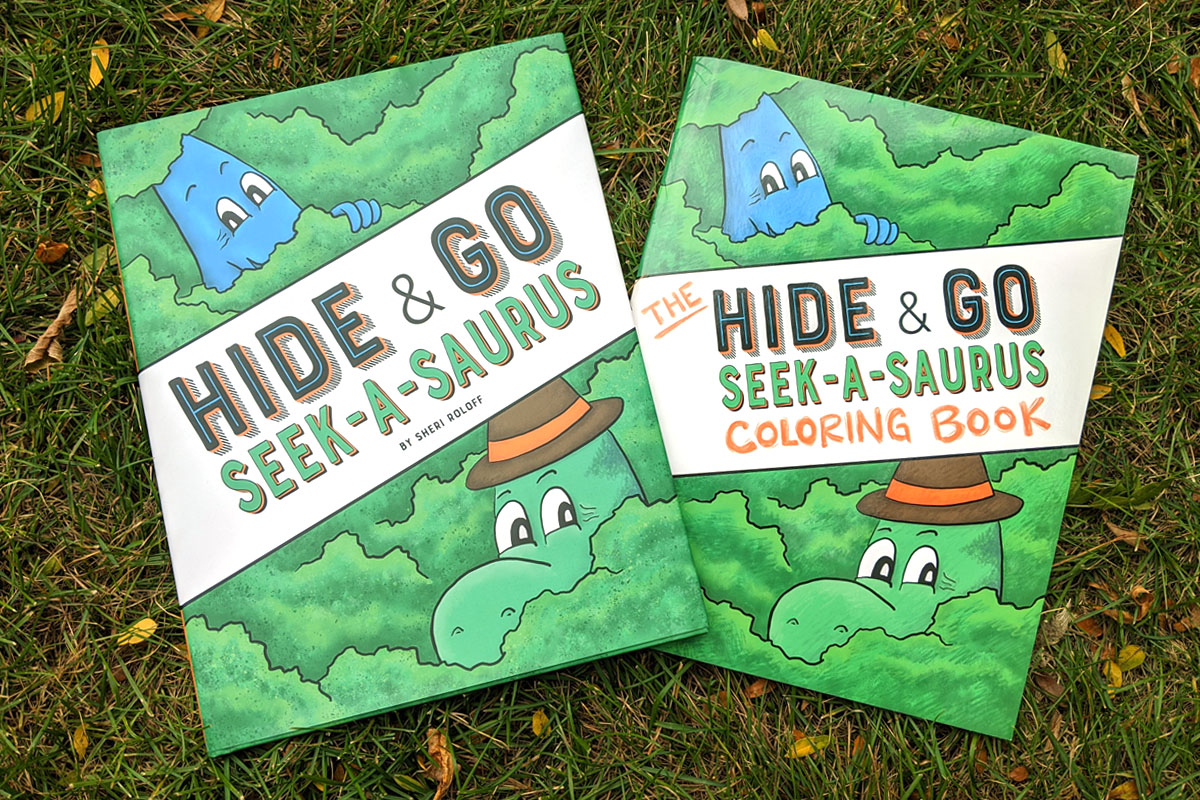 Hide & Go Seek-A-Saurus picture book and coloring book laying in the grass